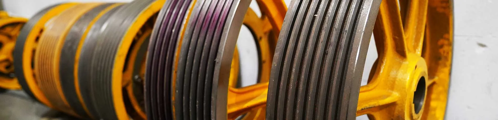 Traction sheave grooves showing differential wear across the rope set